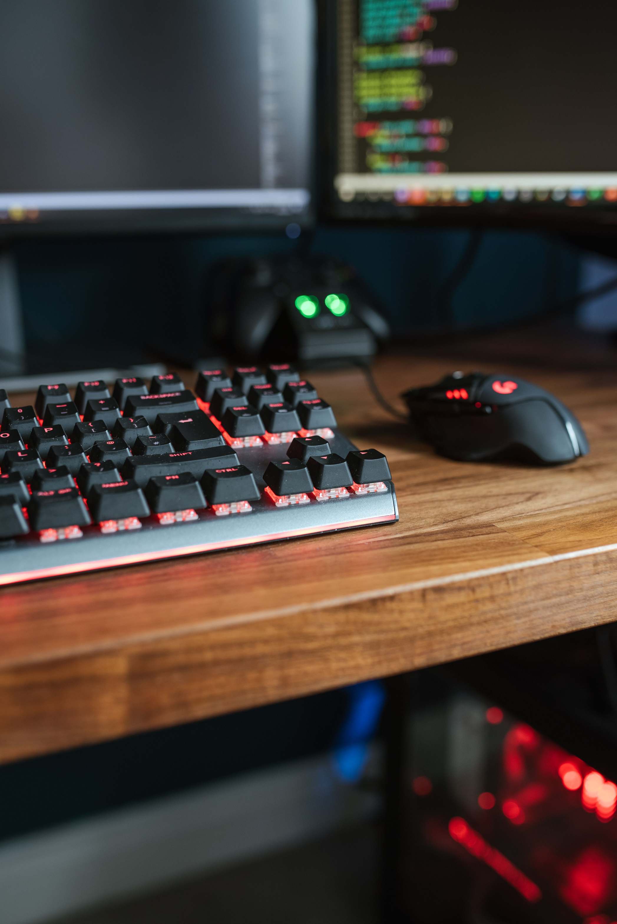 Developer workspace with monitors and keyboard with programming codes on desk